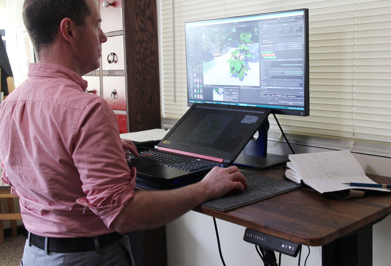 Kris mostly uses his work space for making video games these days and all that programming can be a strain on his back. This table changes height so that he can stand for a spell when he needs to.