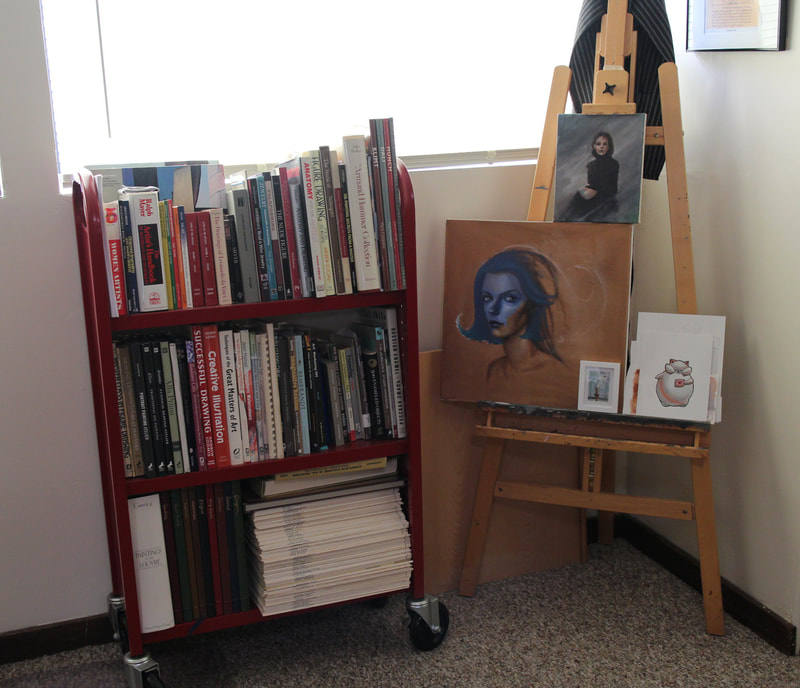 We keep some of our art reference library here in the studio and it keeps my second easel of unfinished works company. It also partially hides said easel of shame from my view during the workday.